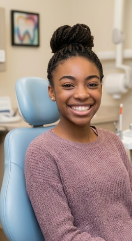Teen smiling in a dental clinic chair